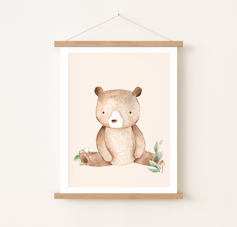 May include: A watercolor illustration of a brown bear sitting on a log with green leaves and pink flowers. The bear has a light brown nose and light brown fur.