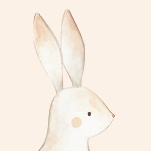 May include: A watercolor illustration of a white rabbit with brown ears and a pink nose. The rabbit is looking to the right and has a small brown spot on its cheek.