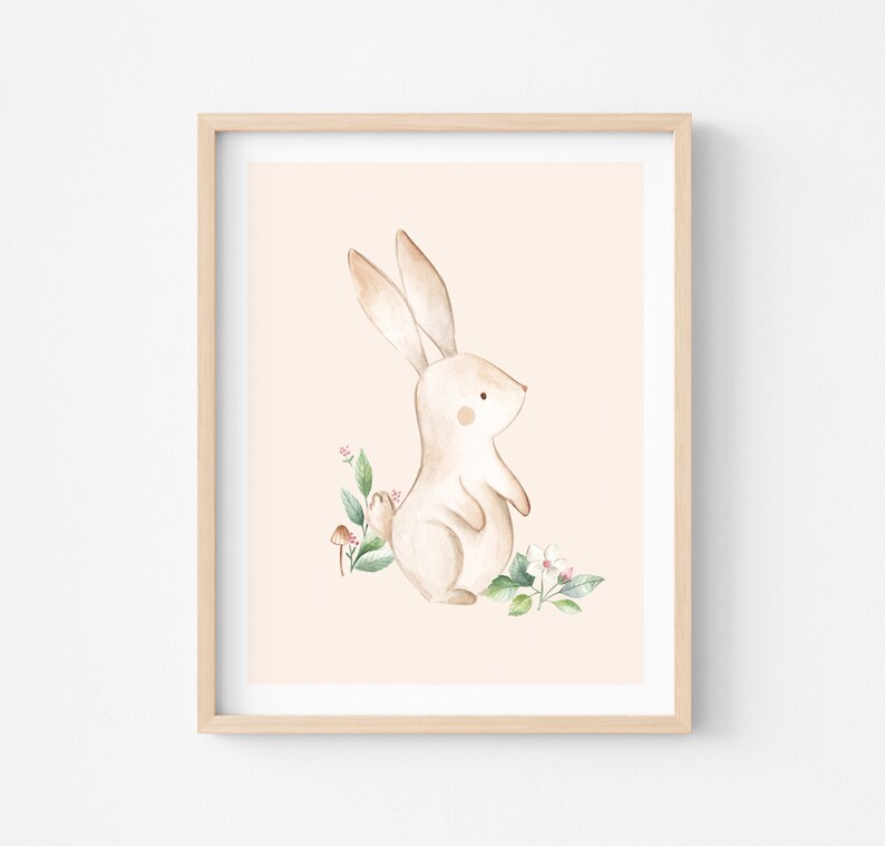 May include: A watercolor illustration of a brown bunny rabbit standing on its hind legs with its front paws raised. The bunny is surrounded by green leaves and pink flowers on a light peach background.
