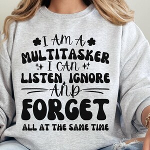 May include: Gray sweatshirt with a black graphic print that reads "I am a multitasker I can listen, ignore and forget all at the same time".
