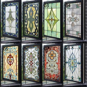 May include: A collection of eight stained glass window panels in black frames. Each panel showcases a unique design, incorporating colours such as blue, green, yellow, and red. The designs vary from floral patterns to geometric shapes, providing diverse decorative choices.