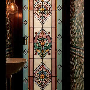 May include: A decorative stained glass door with a floral design. The door features a symmetrical pattern with pastel colours, including pink, blue, yellow, and green. The glass is framed by black lines, and the door is set in a dark wood frame.