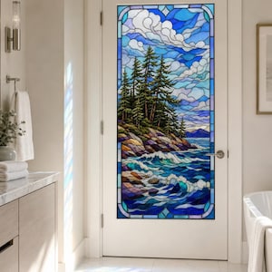 May include: A white interior door featuring a large rectangular stained glass panel. The glass depicts a coastal landscape with evergreen trees on a rocky shoreline, crashing ocean waves, and a cloudy blue sky rendered in various shades of blue.