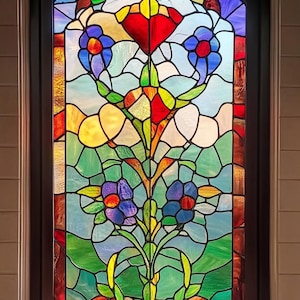 May include: A stained glass window featuring a floral design. The window depicts a red, yellow, and green flower with blue petals. The background is a light blue and green.