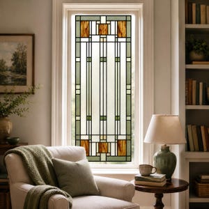 May include: A rectangular window panel featuring a geometric stained glass design. The pattern consists of vertical lines in sage green and clear glass, accented by square amber-colored glass inserts at the top and bottom sections.