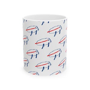 May include: White ceramic mug with a repeating pattern of blue and red cartoon pigs.
