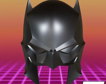 May include: A black, angular, full-head helmet featuring pointed ears and a sharp, geometric design. The helmet has a smooth, matte finish with distinct, faceted surfaces that create a structured, rigid appearance. The text J3D is visible.