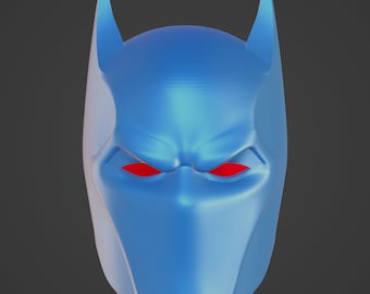 May include: A blue superhero mask with pointed ears and red eye openings. The mask has a smooth, reflective surface and is designed to cover the entire head. The mask is a solid color with no additional patterns or designs.