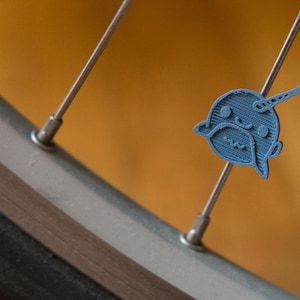 Cute Narwhal bike spoke decoration. Fits on bicycle wheel spokes. Accessory clips on bike spokes like spoke beads. Made in USA