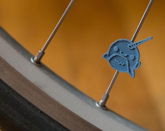 Cute Narwhal bike spoke decoration. Fits on bicycle wheel spokes. Accessory clips on bike spokes like spoke beads. Made in USA