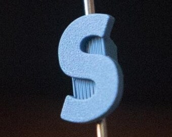 Letter "S" Bike Spoke Decoration. Fits on bicycle wheel spokes. Accessory clips onto bike spokes like spoke beads. Made in USA.