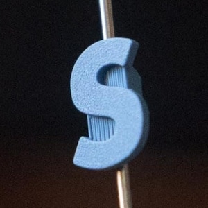 Letter &quot;S&quot; Bike Spoke Decoration. Fits on bicycle wheel spokes. Accessory clips onto bike spokes like spoke beads. Made in USA.