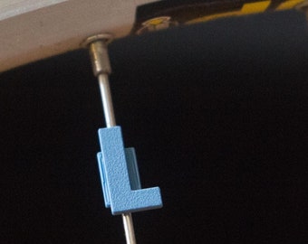 Letter "L" Bike Spoke Decoration. Fits on bicycle wheel spokes. Accessory clips onto bike spokes like spoke beads. Made in USA.