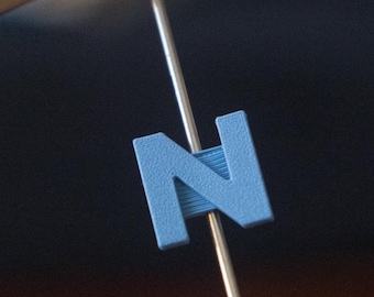 Letter "N" Bike Spoke Decoration. Fits on bicycle wheel spokes. Accessory clips onto bike spokes like spoke beads. Made in USA.