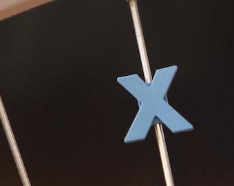 Letter "X" Bike Spoke Decoration. Fits on bicycle wheel spokes. Accessory clips onto bike spokes like spoke beads. Made in USA.
