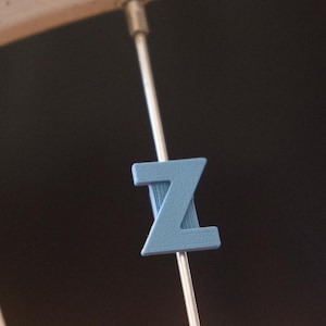 Letter &quot;Z&quot; Bike Spoke Decoration. Fits on bicycle wheel spokes. Accessory clips onto bike spokes like spoke beads. Made in USA.