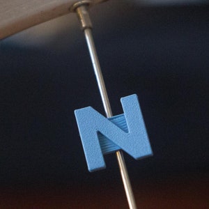 Letter &quot;N&quot; Bike Spoke Decoration. Fits on bicycle wheel spokes. Accessory clips onto bike spokes like spoke beads. Made in USA.