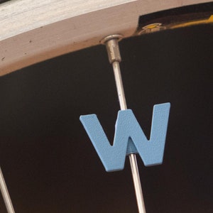 Letter &quot;W&quot; Bike Spoke Decoration. Fits on bicycle wheel spokes. Accessory clips onto bike spokes like spoke beads. Made in USA.