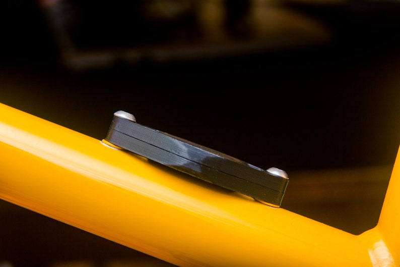Side view of the Bicycle AirTag mount showing the AirTag hidden inside the compartment.