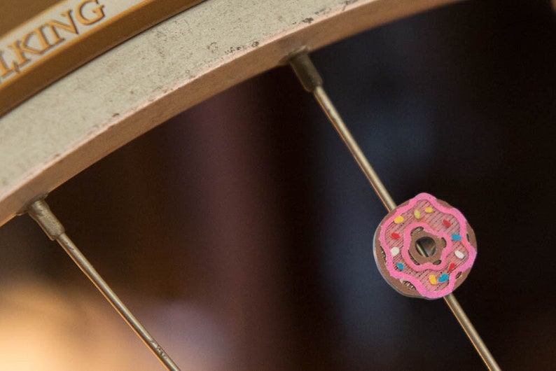 Pink donut with sprinkes spoke decoration and spoke charm for bicycle wheels
