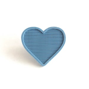 May include: A blue heart-shaped object with a textured surface.