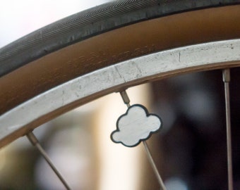Cute cloud bike spoke decoration. Fits on bicycle wheel spokes. Accessory clips on bike spokes like spoke beads. Made in USA