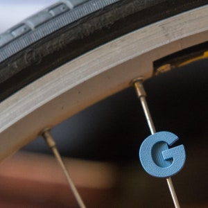 Letter &quot;G&quot; Bike Spoke Decoration. Fits on bicycle wheel spokes. Accessory clips onto bike spokes like spoke beads. Made in USA.