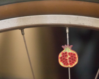 Pomegranate fruit bike spoke decoration. Fits bikes, wheelchairs. Accessory clips on like spoke decorations, beads, charms.