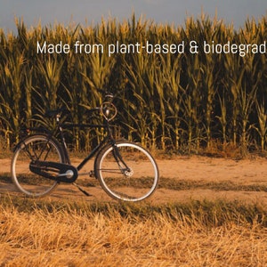 Bicycle in front of cornfield. Plastic used for the AirTag holder is made from bio-based sources.