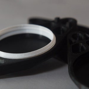 Close up of the Bike Sight hidden AirTag holder (fits under water-bottle mount on bicycle.)