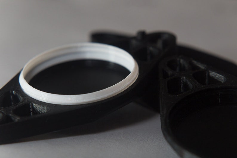 Close up of the Bike Sight hidden AirTag holder (fits under water-bottle mount on bicycle.)