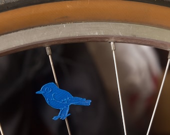 Bird spoke decoration for bikes and wheelchairs. Fits on bicycle wheel spokes. Accessory clips on bike spokes like spoke beads. Made in USA