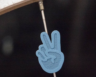 Two finger peace sign bike spoke decoration, made in Oakland, California.