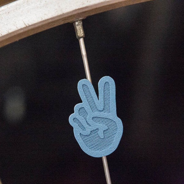 Two finger peace sign bike spoke decoration, made in Oakland, California.