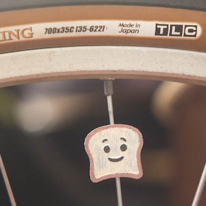 Toast / Bread slice on your bike spokes! Fits bikes, wheelchairs. Accessory clips on like spoke decorations, beads, charms.