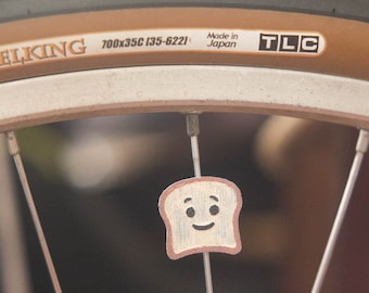 Toast / Bread slice on your bike spokes! Fits bikes, wheelchairs. Accessory clips on like spoke decorations, beads, charms.