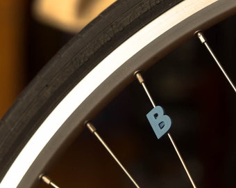 Letter "B" Bike spoke decoration. This accessory clips onto bicycle wheels like a spoke bead. Made in USA.