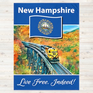 May include: A blue fleece blanket with the state flag of New Hampshire and a train traveling over a bridge in a forest. The text "New Hampshire" and "Live Free. Indeed!" is printed on the blanket.
