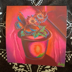 May include: A painting of a butterfly perched on the rim of a terracotta pot with two bright orange and yellow flowers. The background is a vibrant pink.