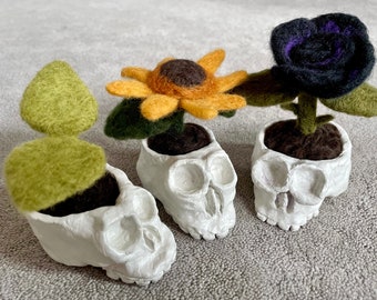 handmade clay skull with needle felted wool plant, sunflower, black rose or sprout, floral macabre gothic garden art