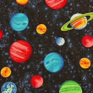 May include: A fabric print featuring a black background filled with a dense field of white stars and various colorful planets. The design includes red, blue, yellow, and green spheres, some with textured surfaces and one prominent planet with rings.