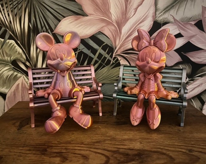 mickey and minni mouse on a bench