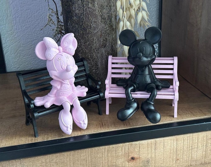 mickey and minni mouse on a bench