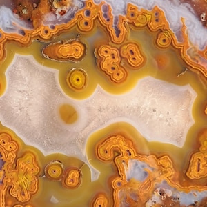 Moroccan agate from the high atlas mountains, also known as hama agate. Polished eye agate mineral specimen with quartz.
