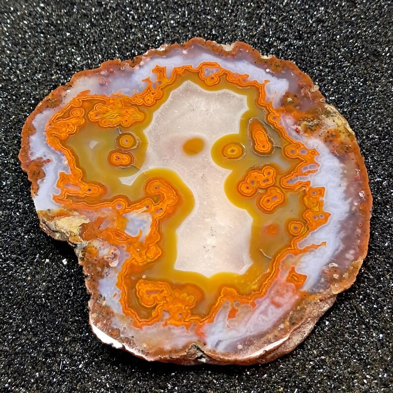 Moroccan agate from the high atlas mountains, also known as hama agate. Polished eye agate mineral specimen with quartz.