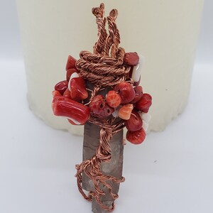 Double sided tree of life wrapped around a smoky quartz crystal, coral chips for the leaves