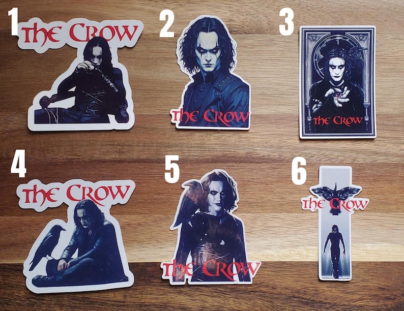 May include: Six different stickers featuring the movie The Crow. Each sticker features a different image of the main character, Eric Draven, and the title of the movie. The stickers are printed on white paper with a glossy finish.