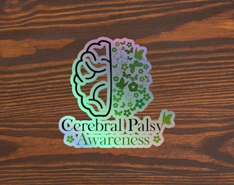 Op de afbeelding: Een sticker met een groene en blauwe iriserende afwerking met een schets van een hersenen waarvan de ene helft is gevuld met groene bloemen en vlinders. De tekst "Cerebral Palsy Awareness" staat onder de hersenen.