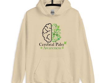 Op de afbeelding: Een beige hoodie met een zwarte omtrek van een brein met groene bloemen en vlinders aan de ene kant. De tekst "Cerebral Palsy Awareness" is onder het brein gedrukt.