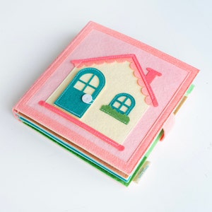 Cover page of dollhouse quiet book, square shaped, felt material, light and soft, with pink house, the door can open and close